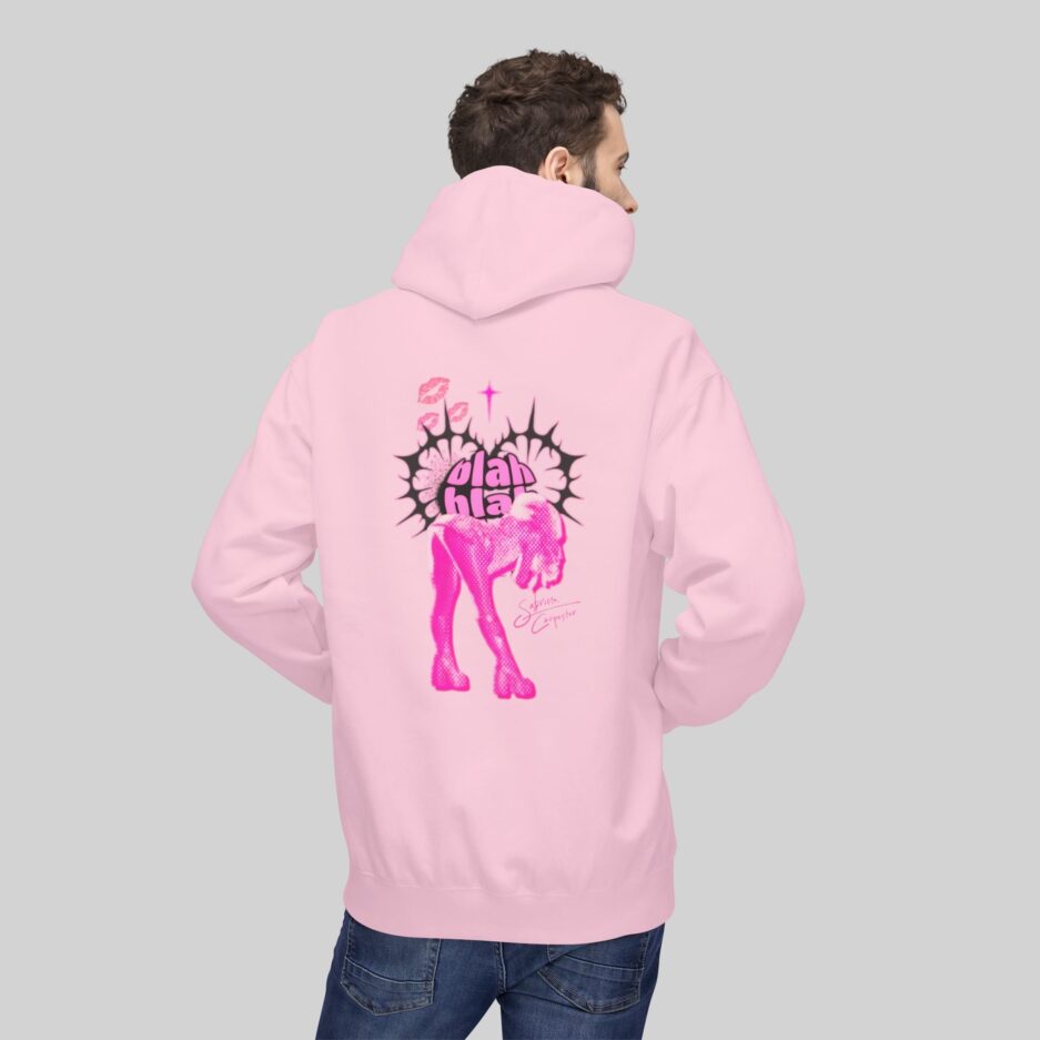 Person wearing a pink Sabrina Carpenter Short n' Sweet Hoodie with a graphic design on the back against a gray background