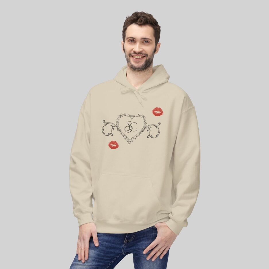 Man wearing a beige Sabrina Carpenter Short n’ Sweet Hoodie with decorative text and lip prints on a light gray background